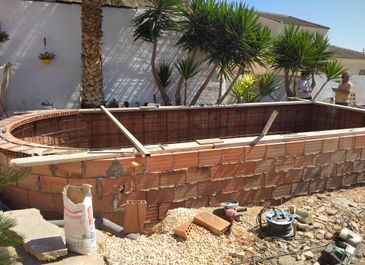 Construction of semi-inground pool by Almeria Builders
